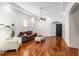 Bright living room featuring hardwood floors, tray ceiling, and neutral decor at 30 Se Wenona Ave, Ocala, FL 34471