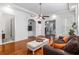 Bright living room featuring hardwood floors, tray ceiling, and neutral decor at 30 Se Wenona Ave, Ocala, FL 34471