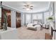 Spacious main bedroom with fireplace, fan, and plenty of natural light at 30 Se Wenona Ave, Ocala, FL 34471