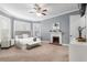 Comfortable main bedroom featuring a fireplace, ceiling fan, and many windows at 30 Se Wenona Ave, Ocala, FL 34471