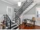 Elegant staircase with wrought iron railing and adjacent office space at 30 Se Wenona Ave, Ocala, FL 34471