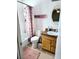 Bright bathroom featuring a tub with shower and vanity with oval mirror at 310 Oak Track Dr, Ocala, FL 34472