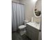 Functional bathroom featuring a vanity, a toilet, neutral-colored walls, and a shower with a curtain rod at 310 Oak Track Dr, Ocala, FL 34472