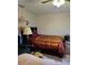 Comfortable bedroom featuring a full-sized bed, a ceiling fan, and warm lighting, creating an inviting and functional space at 310 Oak Track Dr, Ocala, FL 34472