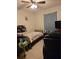 Modest bedroom featuring a twin bed, a ceiling fan, tiled flooring, and essential furnishings for a cozy space at 310 Oak Track Dr, Ocala, FL 34472