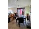 Bright dining area with a marble table, seating for four, tiled flooring, and sliding glass doors to the outdoor space at 310 Oak Track Dr, Ocala, FL 34472