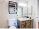 Neutral bathroom features modern lighting, wood cabinets, and tiled backsplash at 3650 Ne 21St St, Ocala, FL 34470