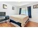 Cozy bedroom with hardwood floors, a queen-sized bed, and a large window at 3650 Ne 21St St, Ocala, FL 34470