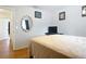 Well-lit bedroom with hardwood floors, a queen-sized bed, and minimal decor at 3650 Ne 21St St, Ocala, FL 34470