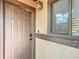 The front door entrance with secure lock, a window, and an outdoor light fixture at 3650 Ne 21St St, Ocala, FL 34470