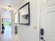 Hallway featuring a mirror, light, and access to other rooms at 3650 Ne 21St St, Ocala, FL 34470