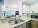 Open concept kitchen featuring a stainless steel dishwasher and a breakfast bar at 3650 Ne 21St St, Ocala, FL 34470