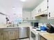 The kitchen features a stainless steel dishwasher and a view into the dining room at 3650 Ne 21St St, Ocala, FL 34470