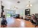 Bright living room with dark leather sofa and view to back yard through sliding glass doors at 3650 Ne 21St St, Ocala, FL 34470
