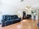 Living room area with wood-look floors and view into the kitchen at 3650 Ne 21St St, Ocala, FL 34470