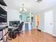 Open living space featuring wood-look floors, chandelier, and view to the kitchen at 3650 Ne 21St St, Ocala, FL 34470