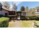 Private backyard entrance with lush greenery, gate, and charming accents, creating a tranquil outdoor space at 411 Sw 38Th St, Ocala, FL 34471