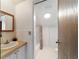 Clean bathroom features white tile, wood vanity, shower with curtain, and excellent lighting at 411 Sw 38Th St, Ocala, FL 34471