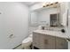 Bathroom with gray vanity, marble countertop and large mirror at 411 Sw 38Th St, Ocala, FL 34471