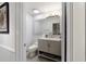 Bathroom with gray vanity, updated fixtures, and neutral paint at 411 Sw 38Th St, Ocala, FL 34471