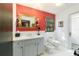 Bright bathroom with colorful accents, a modern vanity, and unique fixtures, offering comfort and style at 411 Sw 38Th St, Ocala, FL 34471