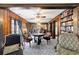 Elegant dining room featuring rich wood paneling, a grand table, and views into the living area at 411 Sw 38Th St, Ocala, FL 34471