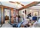 Stylish dining room with seamless view of living room, showcasing wood paneling and elegant furnishings at 411 Sw 38Th St, Ocala, FL 34471