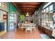 Bright, tiled dining room with a wood ceiling, table, chairs, and bookshelf at 411 Sw 38Th St, Ocala, FL 34471