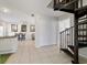 Open entryway featuring tile floors, spiral staircase and kitchen area at 411 Sw 38Th St, Ocala, FL 34471