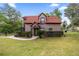 Charming two-story home with a red tile roof, manicured landscaping, and a cozy entrance at 411 Sw 38Th St, Ocala, FL 34471