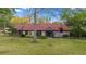 Charming home with a red tiled roof, stone accents, and a lush green lawn, creating a picturesque curb appeal at 411 Sw 38Th St, Ocala, FL 34471