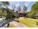 Charming home with a beautiful front yard, walkway, mature trees, and manicured hedges at 411 Sw 38Th St, Ocala, FL 34471