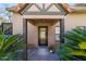 Inviting front entrance showcasing a stylish door, mature palms, and manicured landscaping at 411 Sw 38Th St, Ocala, FL 34471