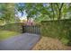Metal driveway gate with climbing vines, offering privacy and elegance to the property at 411 Sw 38Th St, Ocala, FL 34471