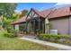 Inviting front porch with stone accents, a screened entrance, and manicured greenery enhancing curb appeal at 411 Sw 38Th St, Ocala, FL 34471