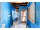 Unique hallway featuring blue walls, textured walls and access to different rooms at 411 Sw 38Th St, Ocala, FL 34471