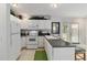 Kitchen with white appliances and breakfast bar, next to French doors at 411 Sw 38Th St, Ocala, FL 34471