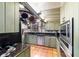 The kitchen is adorned with custom cabinetry, granite countertops, and stainless steel appliances at 411 Sw 38Th St, Ocala, FL 34471
