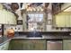 This kitchen features custom cabinetry, granite countertops, and pot rack at 411 Sw 38Th St, Ocala, FL 34471