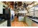 The kitchen offers custom cabinets, granite countertops, stainless steel appliances and a terracotta tile floor at 411 Sw 38Th St, Ocala, FL 34471