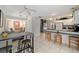 Open-concept kitchen featuring a breakfast bar, tile flooring, and ample cabinet space at 411 Sw 38Th St, Ocala, FL 34471