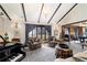 Inviting living room featuring beamed ceilings, a grand piano, and patterned carpeting for a stylish touch at 411 Sw 38Th St, Ocala, FL 34471