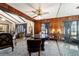 Elegant living room features wood paneling, beamed ceilings and an animal print rug at 411 Sw 38Th St, Ocala, FL 34471