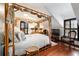 Main bedroom with hardwood floors and canopy bed at 411 Sw 38Th St, Ocala, FL 34471