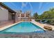Beautiful in-ground swimming pool with a brick paver surround, lounge chairs, and manicured landscaping at 411 Sw 38Th St, Ocala, FL 34471
