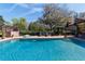 Inviting in-ground pool with brick surround and relaxing chairs offers the perfect backyard space at 411 Sw 38Th St, Ocala, FL 34471