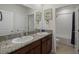 A functional bathroom with a double vanity, granite countertop, and a shower-tub combination, designed for everyday use at 5021 Sw 88Th St, Ocala, FL 34476