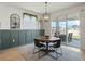 Cozy dining area with a round wooden table, stylish chairs, and a view of the backyard patio at 5021 Sw 88Th St, Ocala, FL 34476