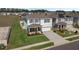 Two-story home showcasing a well-manicured lawn, with a covered porch, and a two car garage at 5021 Sw 88Th St, Ocala, FL 34476