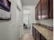Hallway with granite counters and cabinetry leading to a dining area at 5021 Sw 88Th St, Ocala, FL 34476